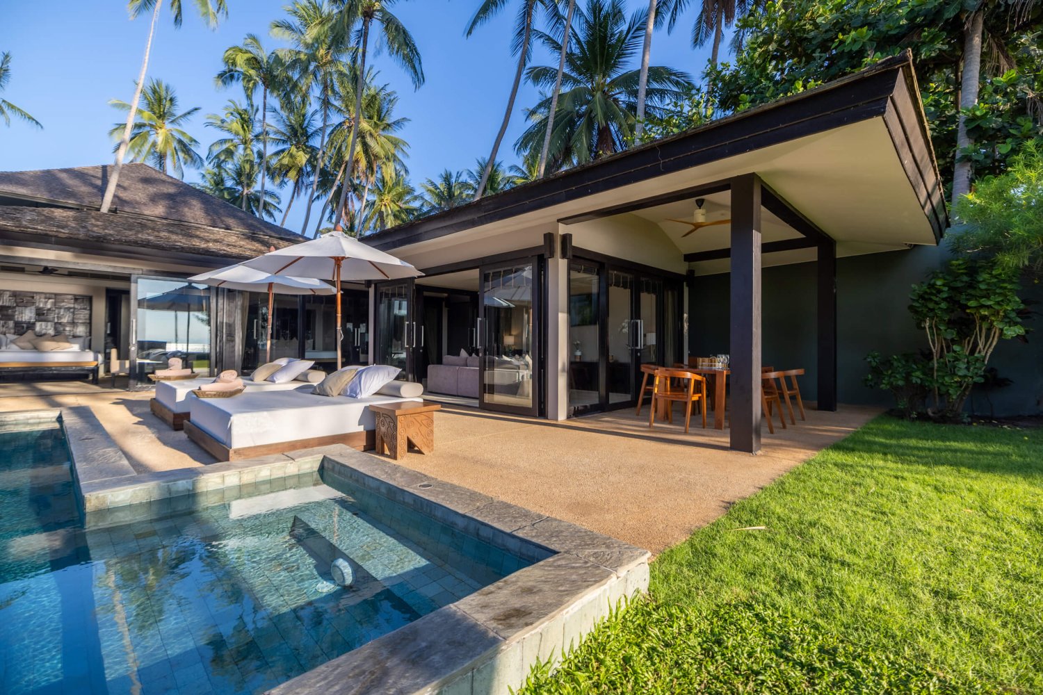 Wide shot of a villa and pool at Nikki Beach Koh Samui