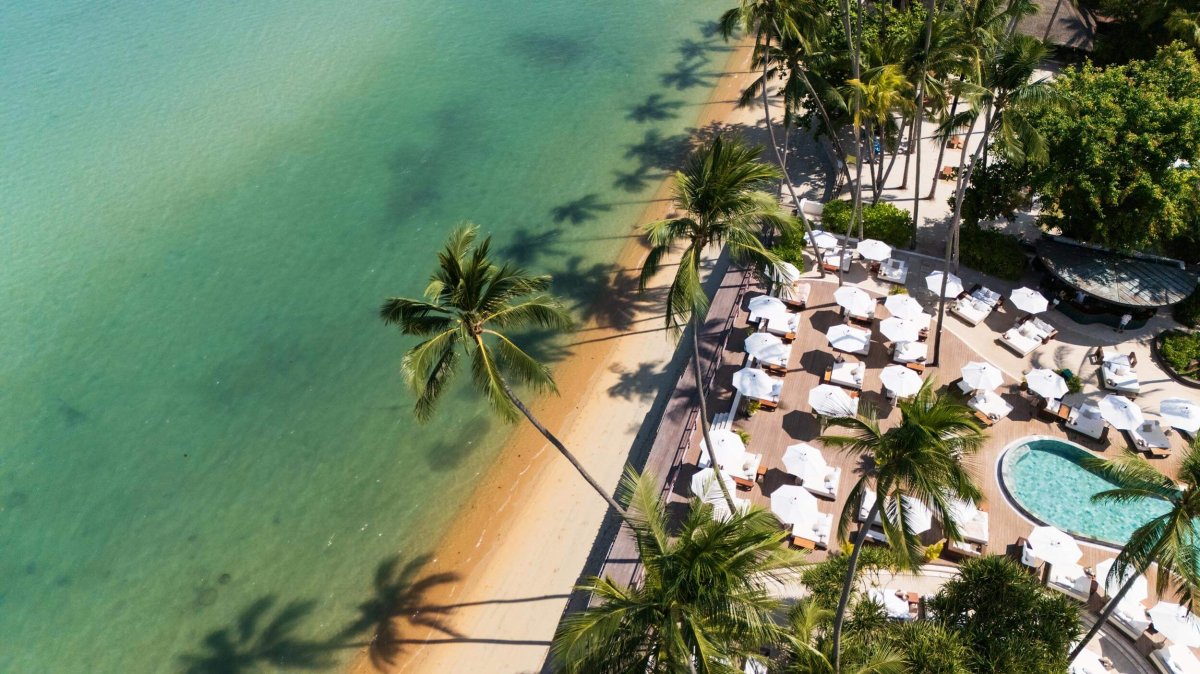 Ariel shot of Nikki Beach pool area next to the sandy beach and sea