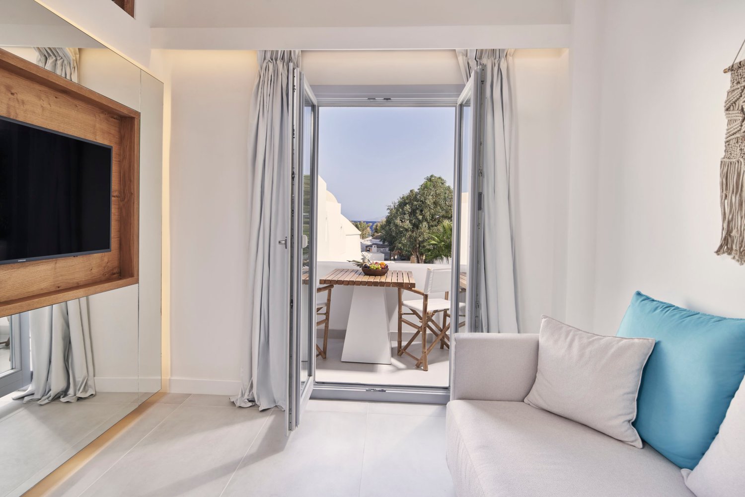 Signature Room: sofa and tv looking out to balcony area