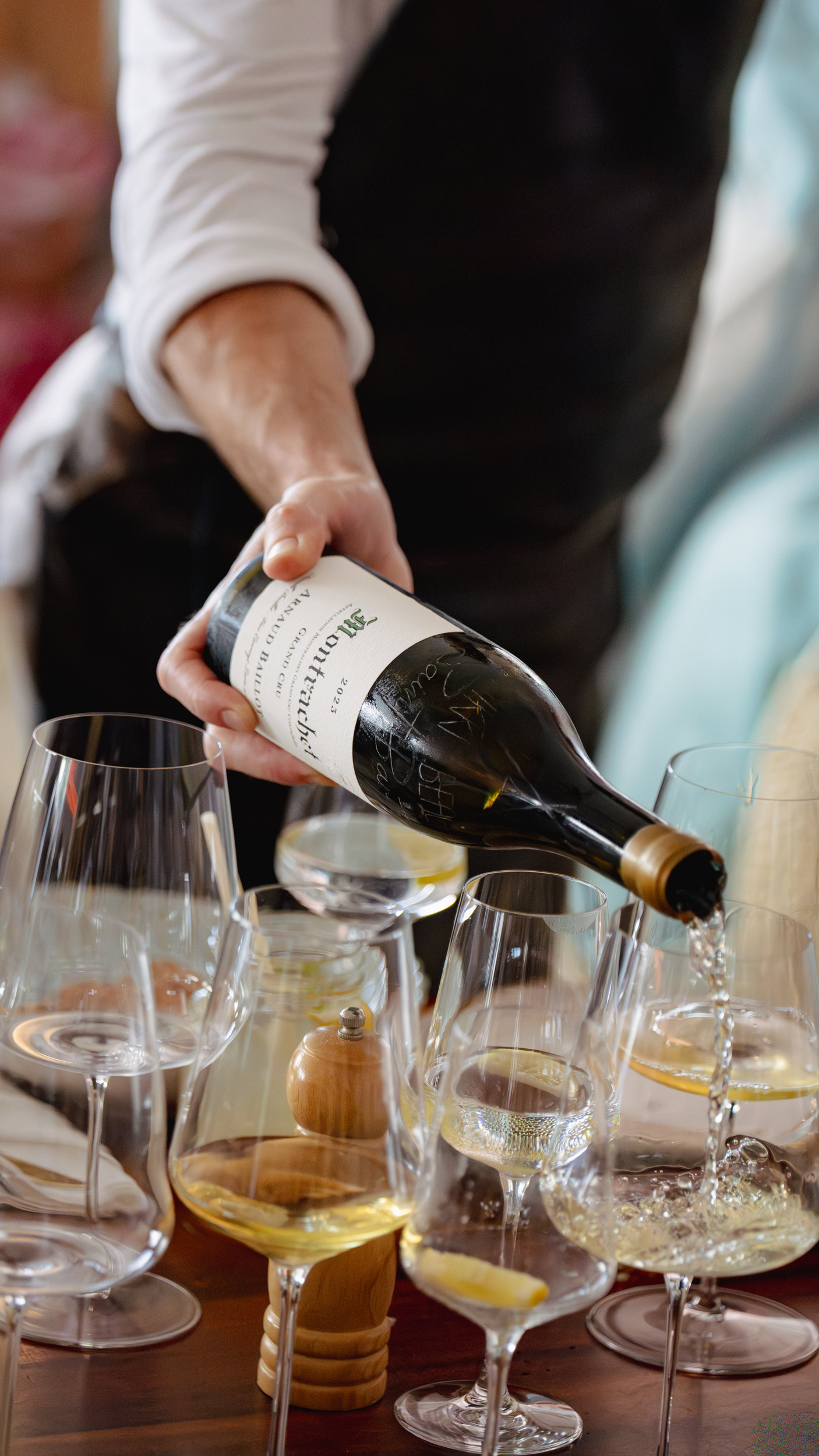 Waiter pouring a glass of wine