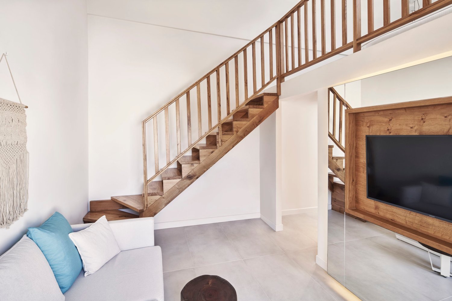 Signature Room with Sea View: Tv and sofa area with stairs up to bedroom