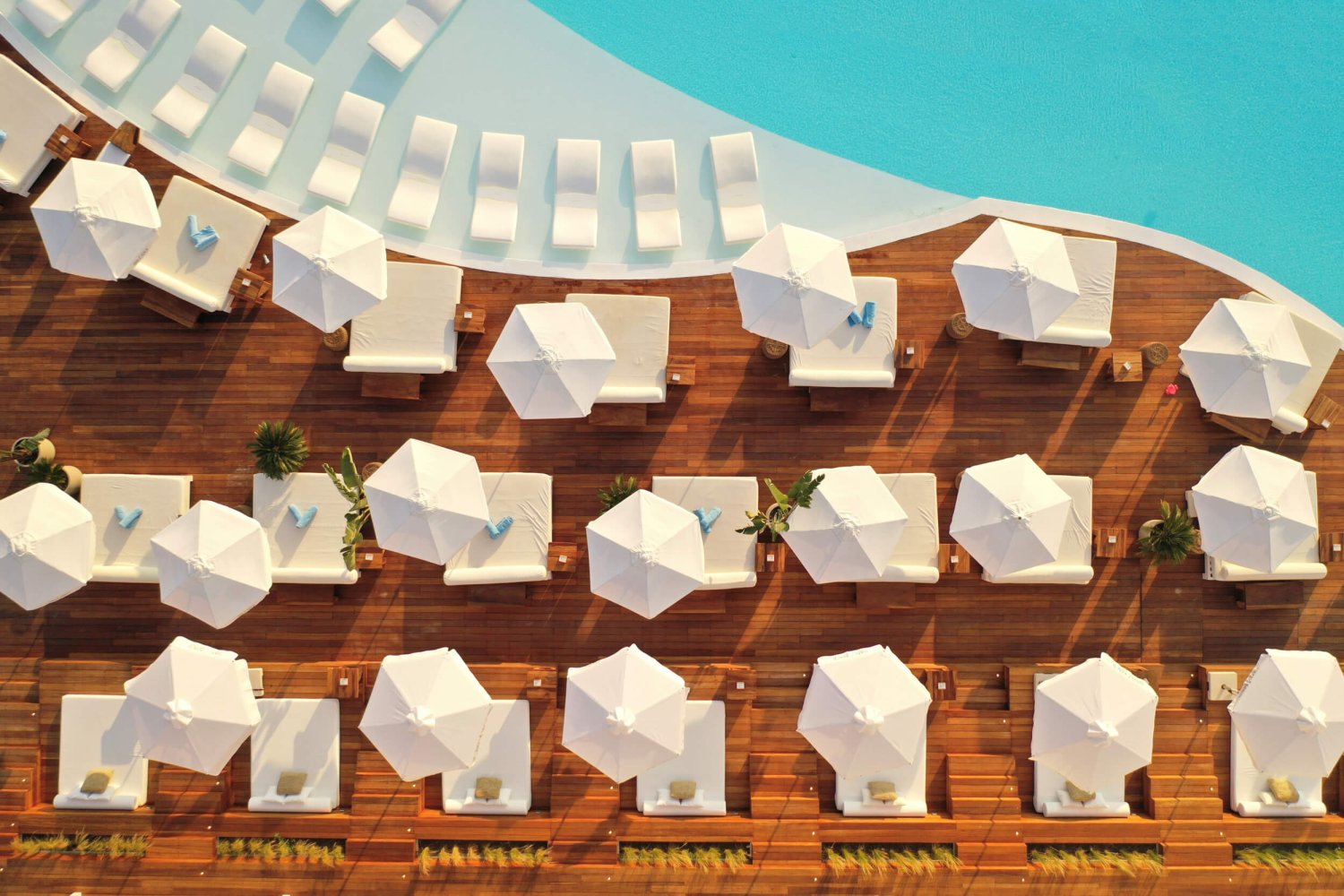 Nikki Beach Porto Heli Drone Shot showing sun beds with umbrellas, sun loungers and pool area