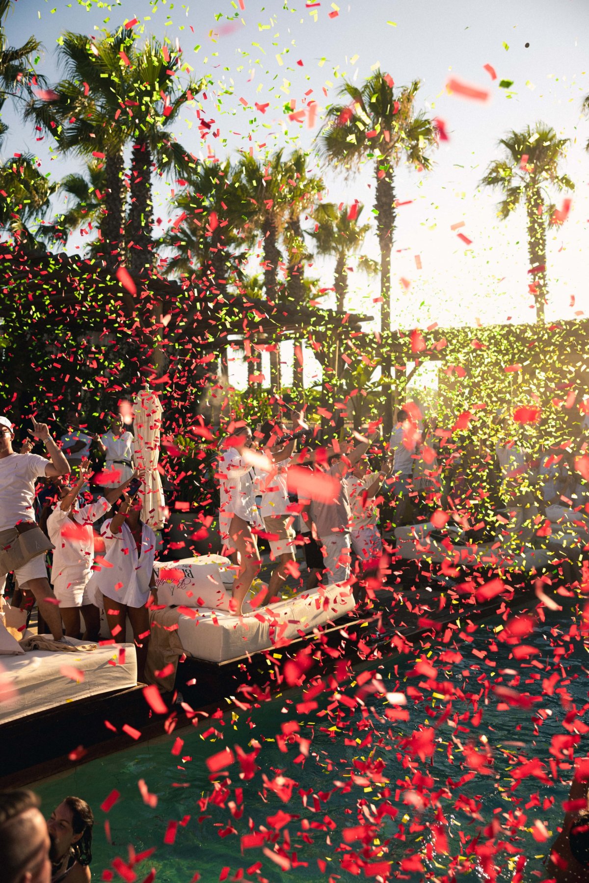 Vibrant colors and pure joy fill the air as guests dance by the pool, surrounded by palm trees and the rhythm of summer. The essence of Nikki Beach: music, happiness, and unforgettable memories